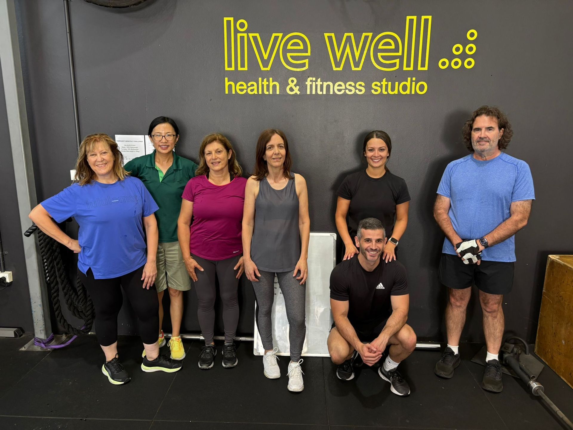 Personal trainer coaching a client during strength training to achieve health and fitness goals at Live Well Fitness